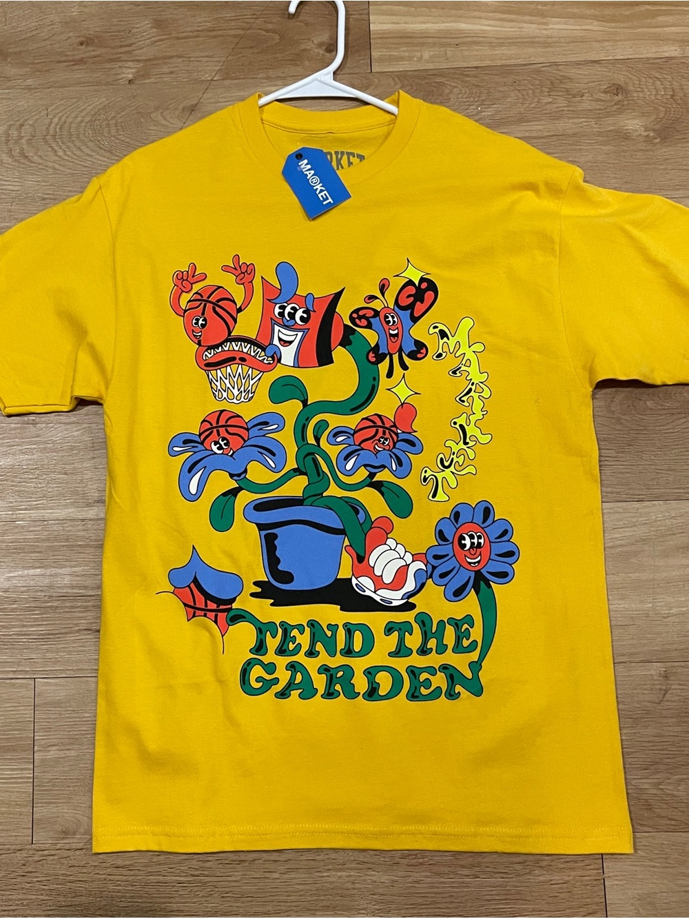 Market
Yellow 'Tend The Garden' Graphic Short-Sleeve Tee with Multicolor Print